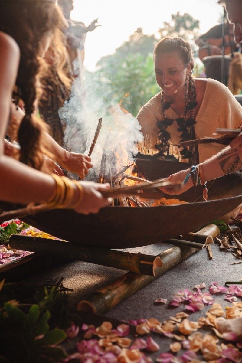 Hands around a ceremonial fire